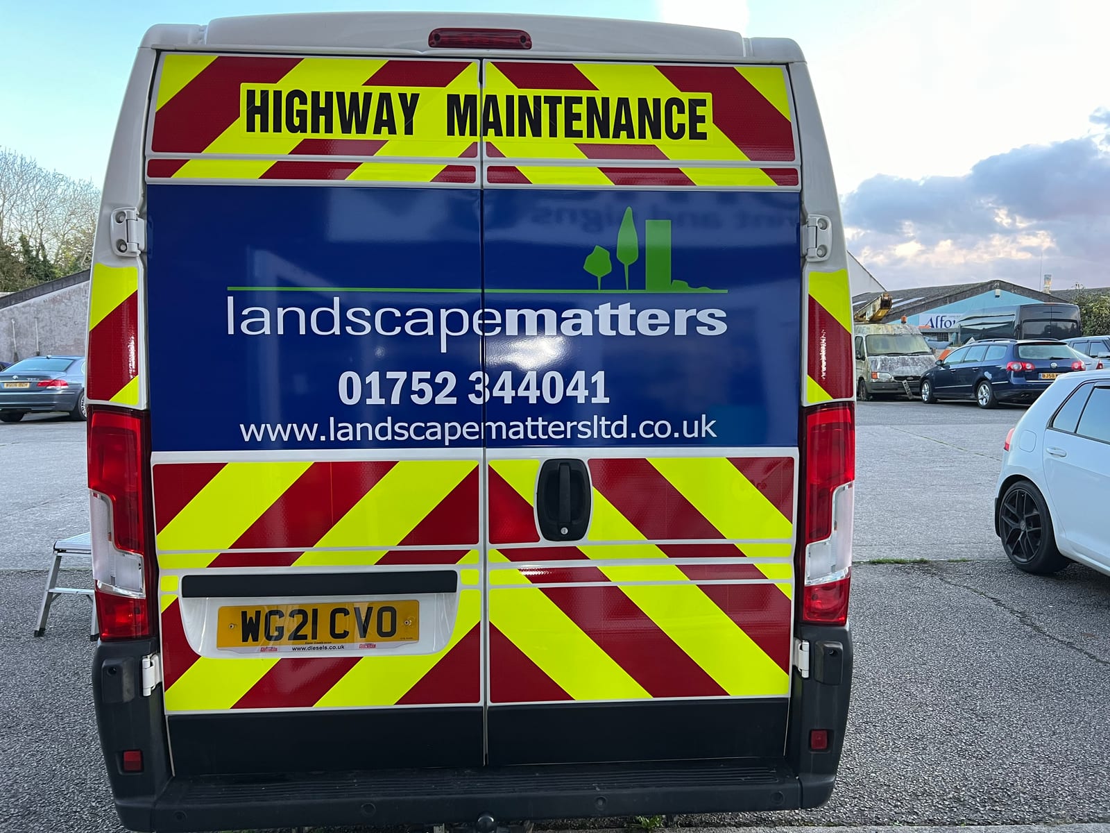 Rear of a works van fitted with a Chapter 8 red-and-yellow chevron kit by Omega Print & Signs